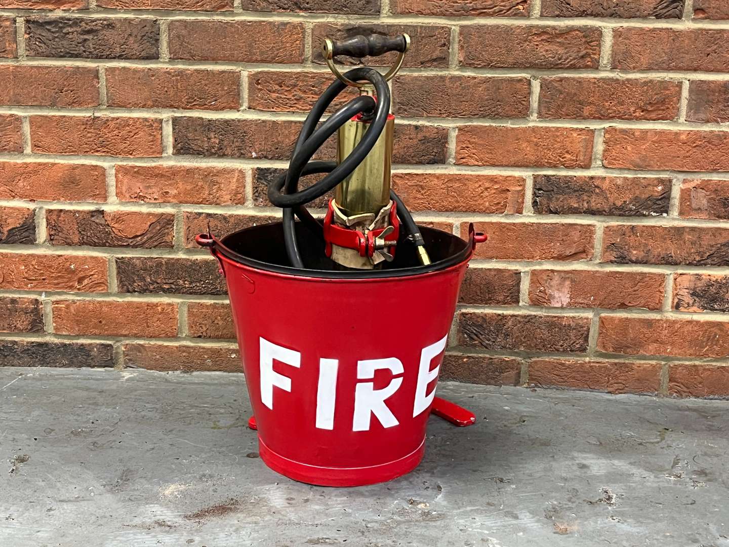 <p>Metal Fire Bucket and Brass Pump on Stand</p>