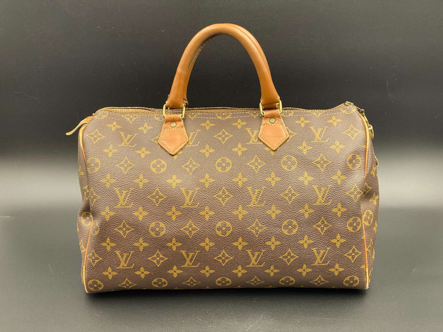 <p>LOUIS VUITTON, Speedy 35, monogram canvas and stitched leather holdall,</p>