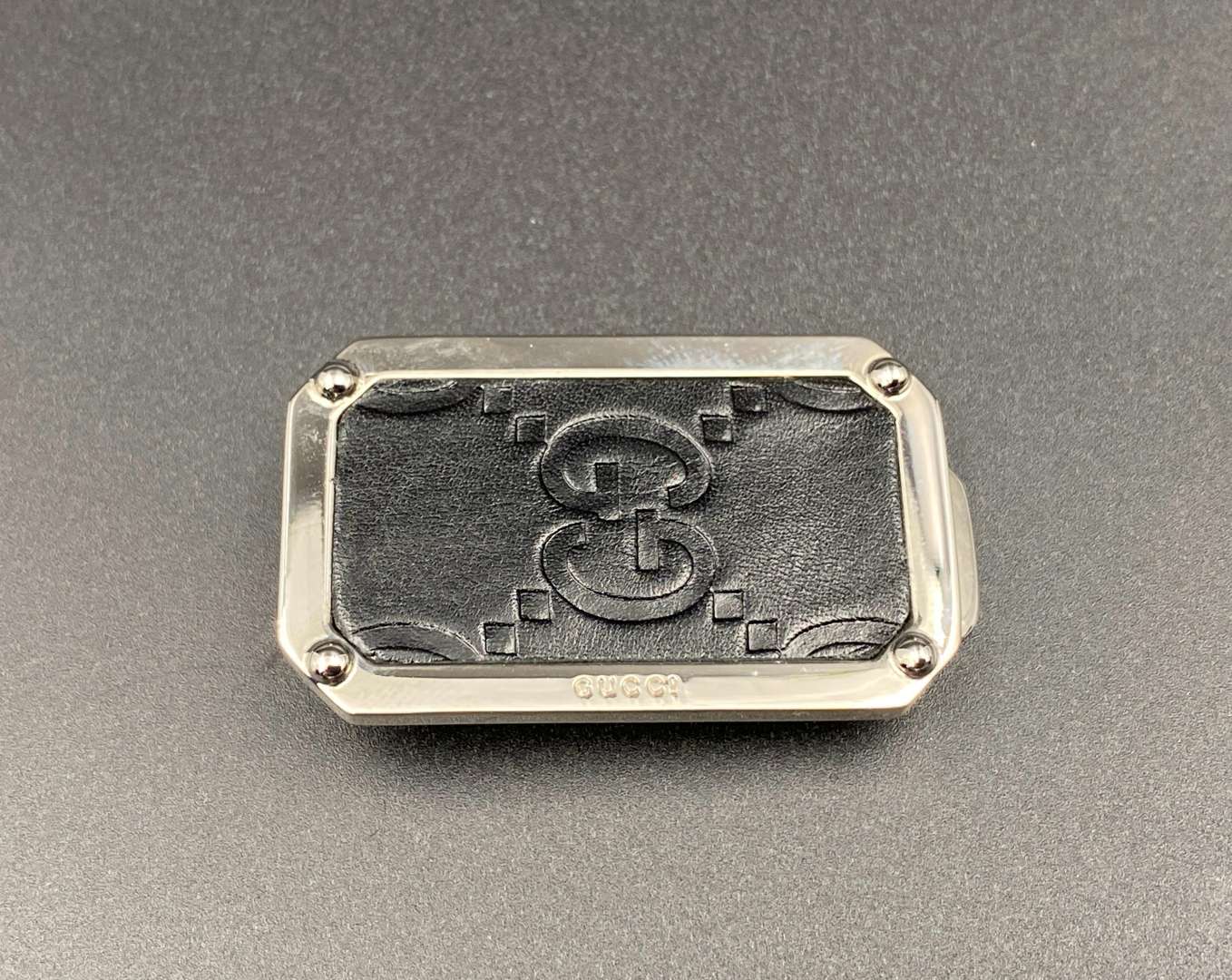 <p>GUCCI, polished stainless steel and monogrammed leather inset money clip,</p>