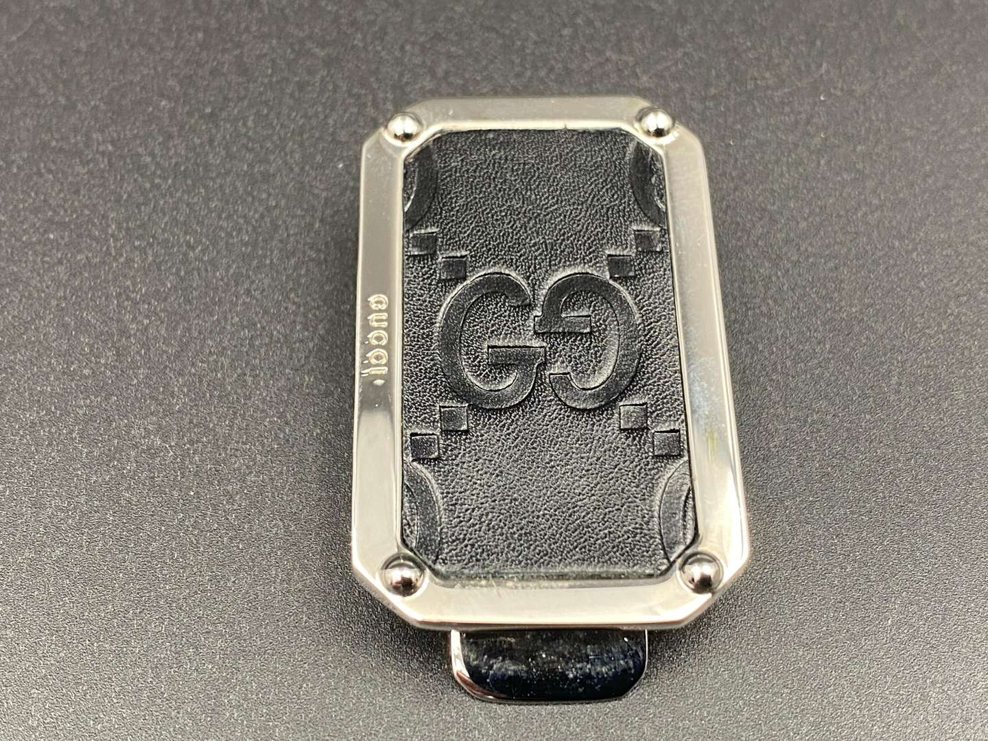 <p>GUCCI, polished stainless steel and monogrammed leather inset money clip,</p>