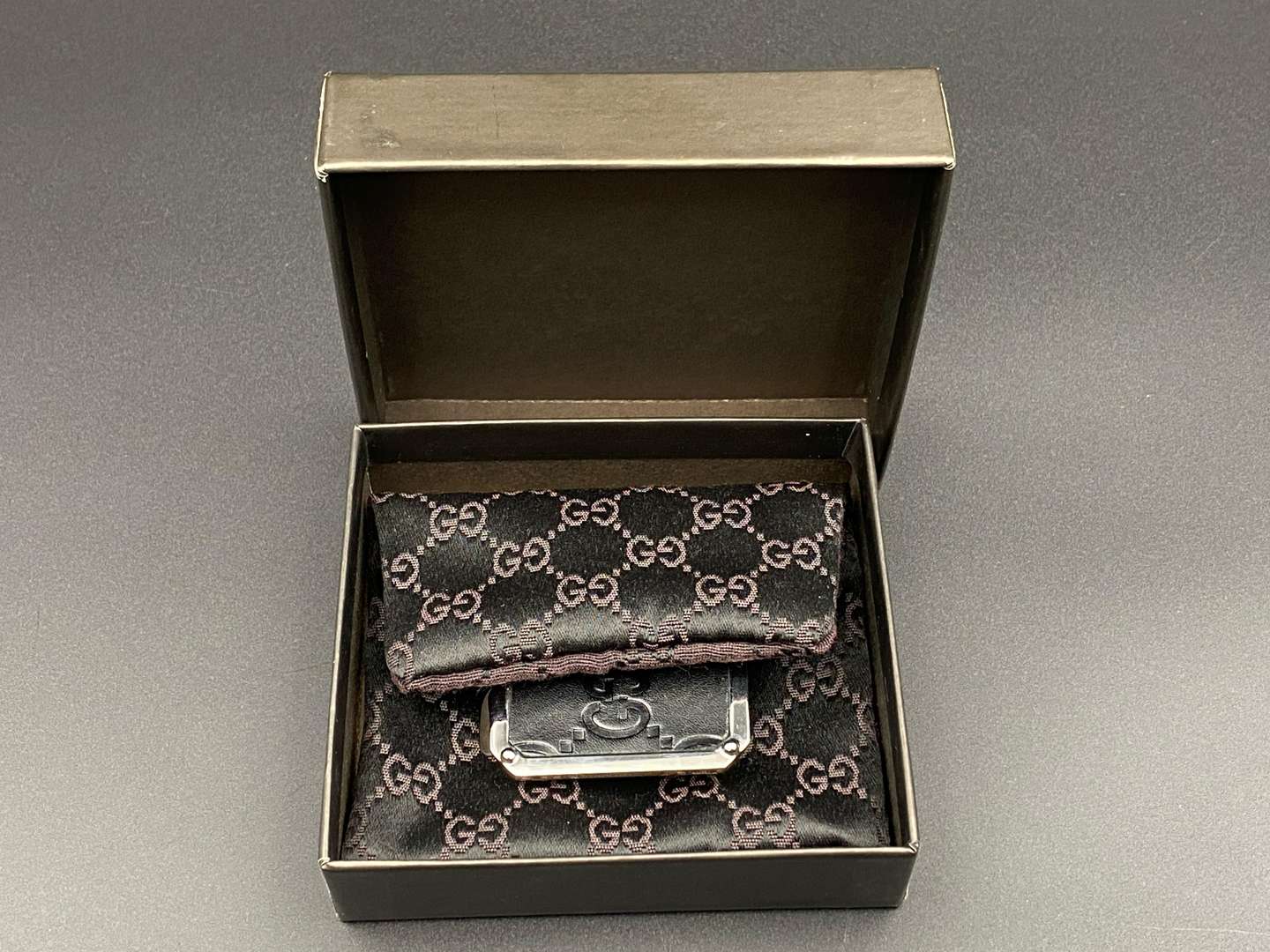 <p>GUCCI, polished stainless steel and monogrammed leather inset money clip,</p>