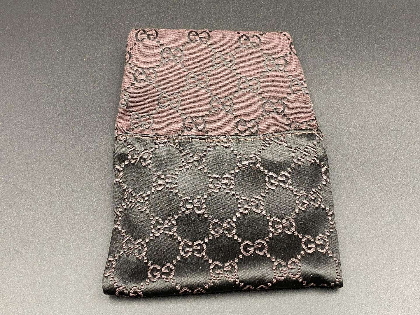 <p>GUCCI, polished stainless steel and monogrammed leather inset money clip,</p>