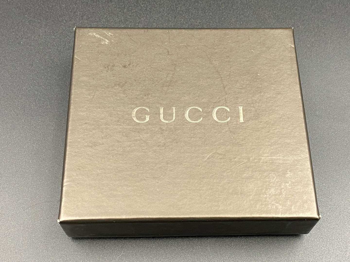 <p>GUCCI, polished stainless steel and monogrammed leather inset money clip,</p>
