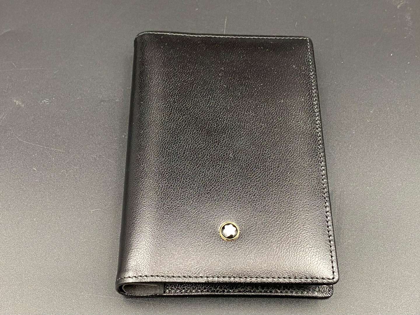 <p>MONT BLANC, a black, stitched leather pocket address book,&nbsp;</p>