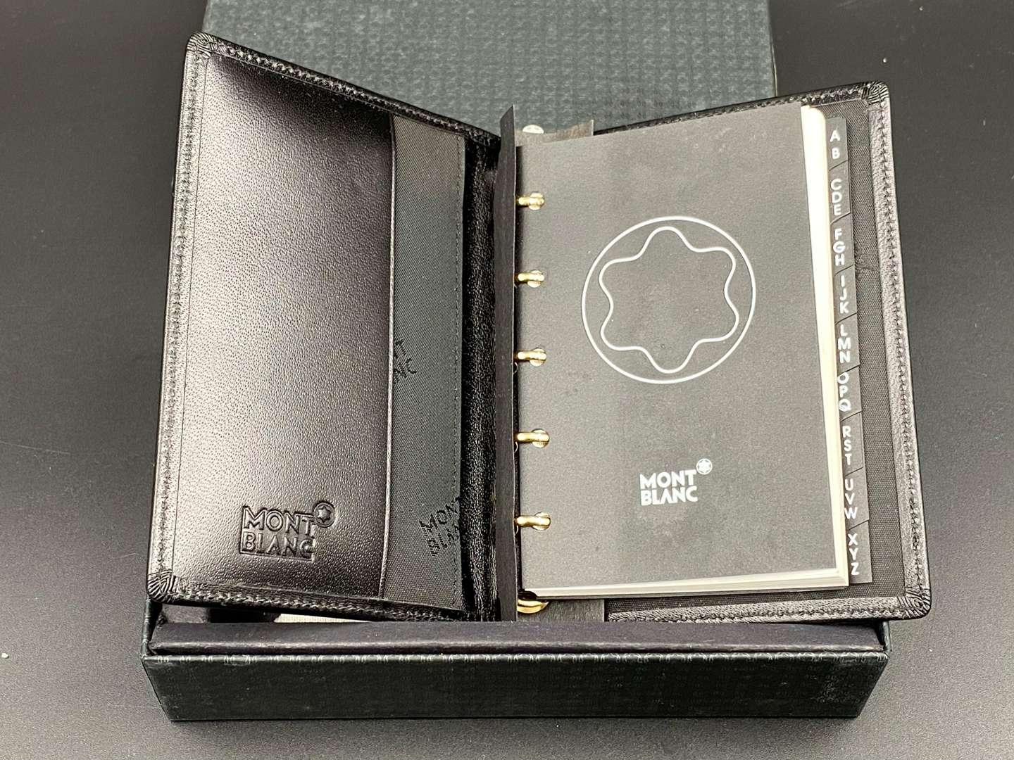 <p>MONT BLANC, a black, stitched leather pocket address book,&nbsp;</p>