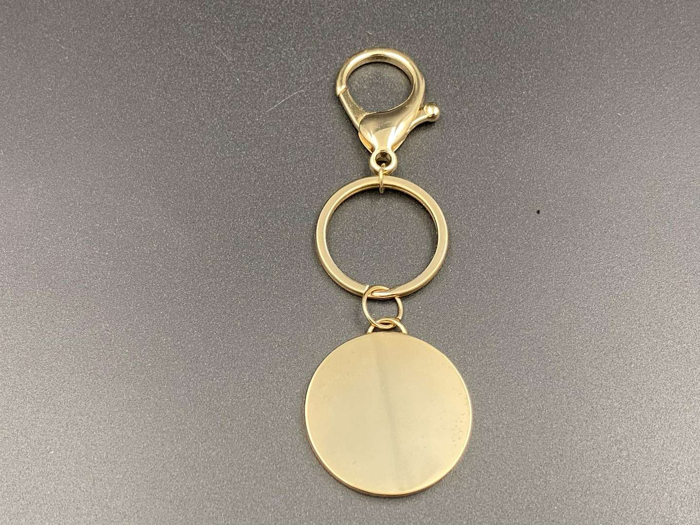 <p>STELLA McCARTNEY, gilt metal key ring and fob,</p>