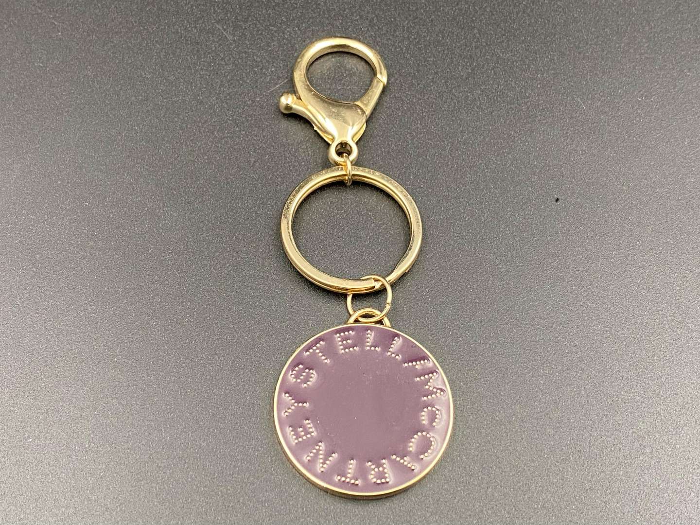 <p>STELLA McCARTNEY, gilt metal key ring and fob,</p>
