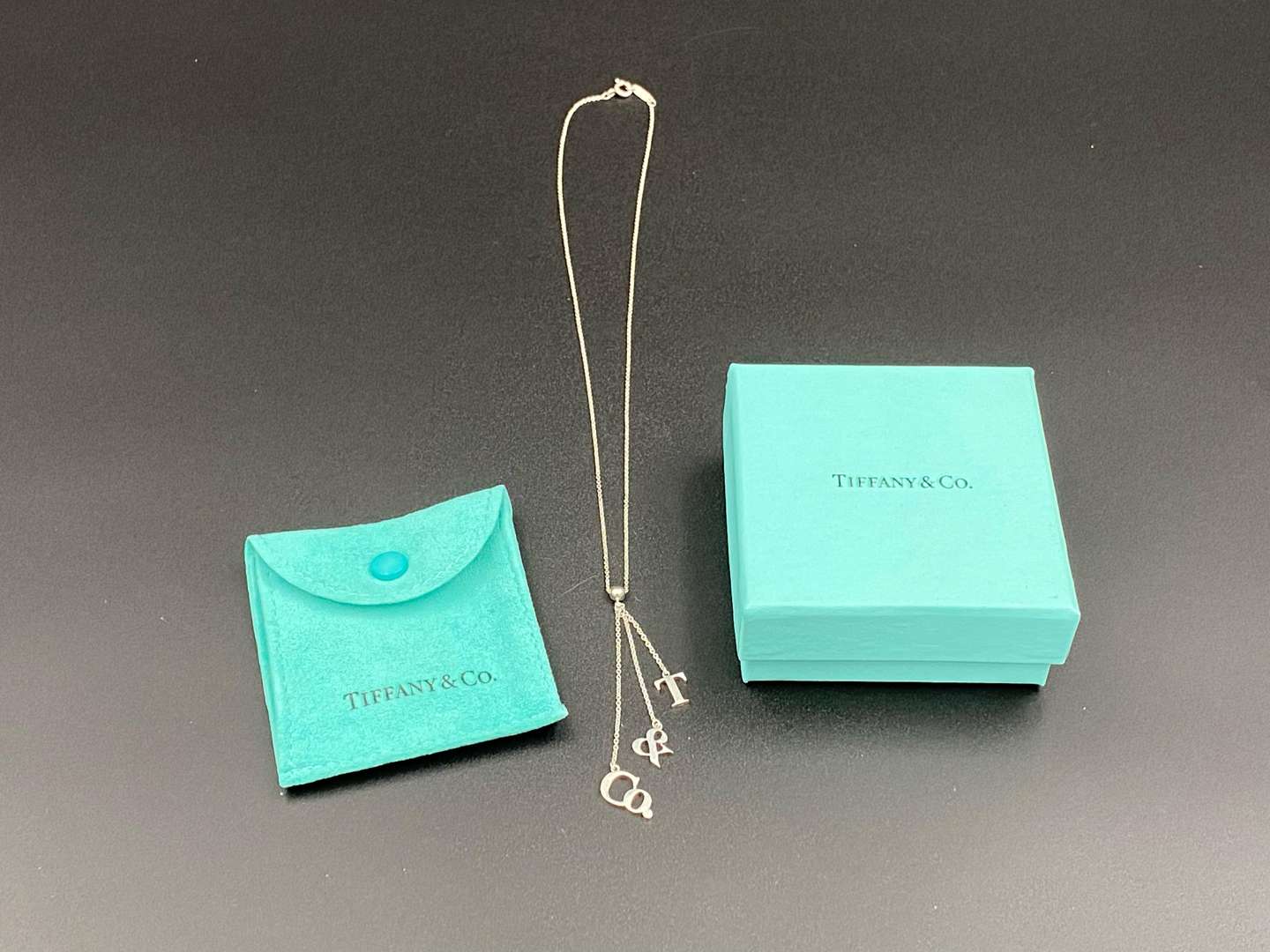 <p>TIFFANY & CO, .925 silver dangle letters necklace.&nbsp;</p>