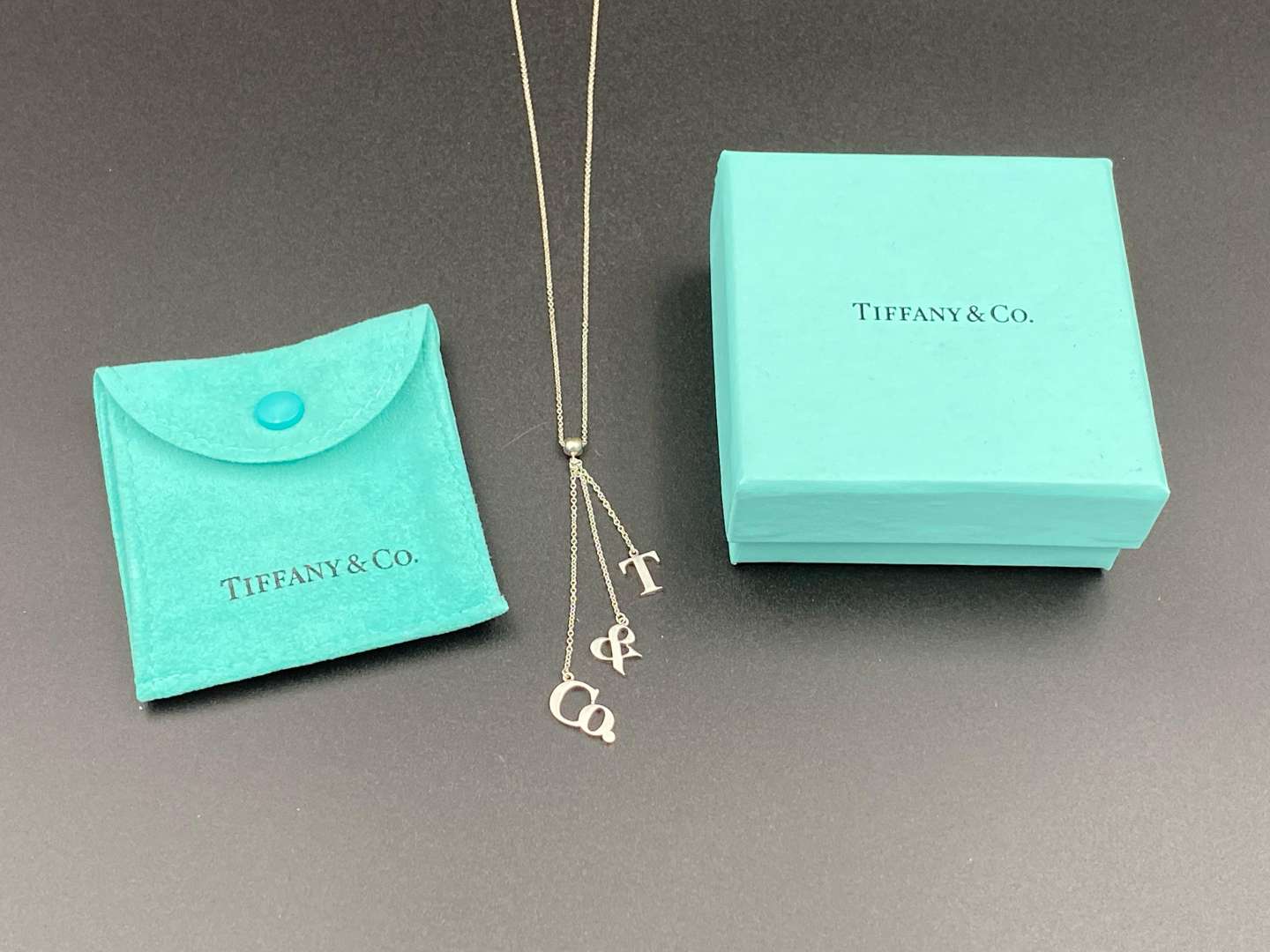 <p>TIFFANY & CO, .925 silver dangle letters necklace.&nbsp;</p>