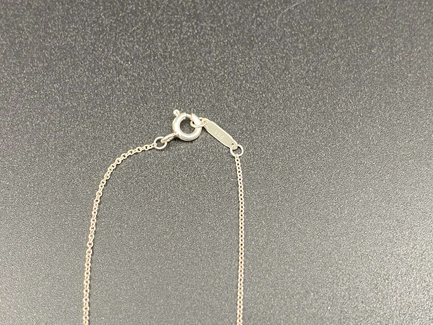 <p>TIFFANY & CO, .925 silver dangle letters necklace.&nbsp;</p>