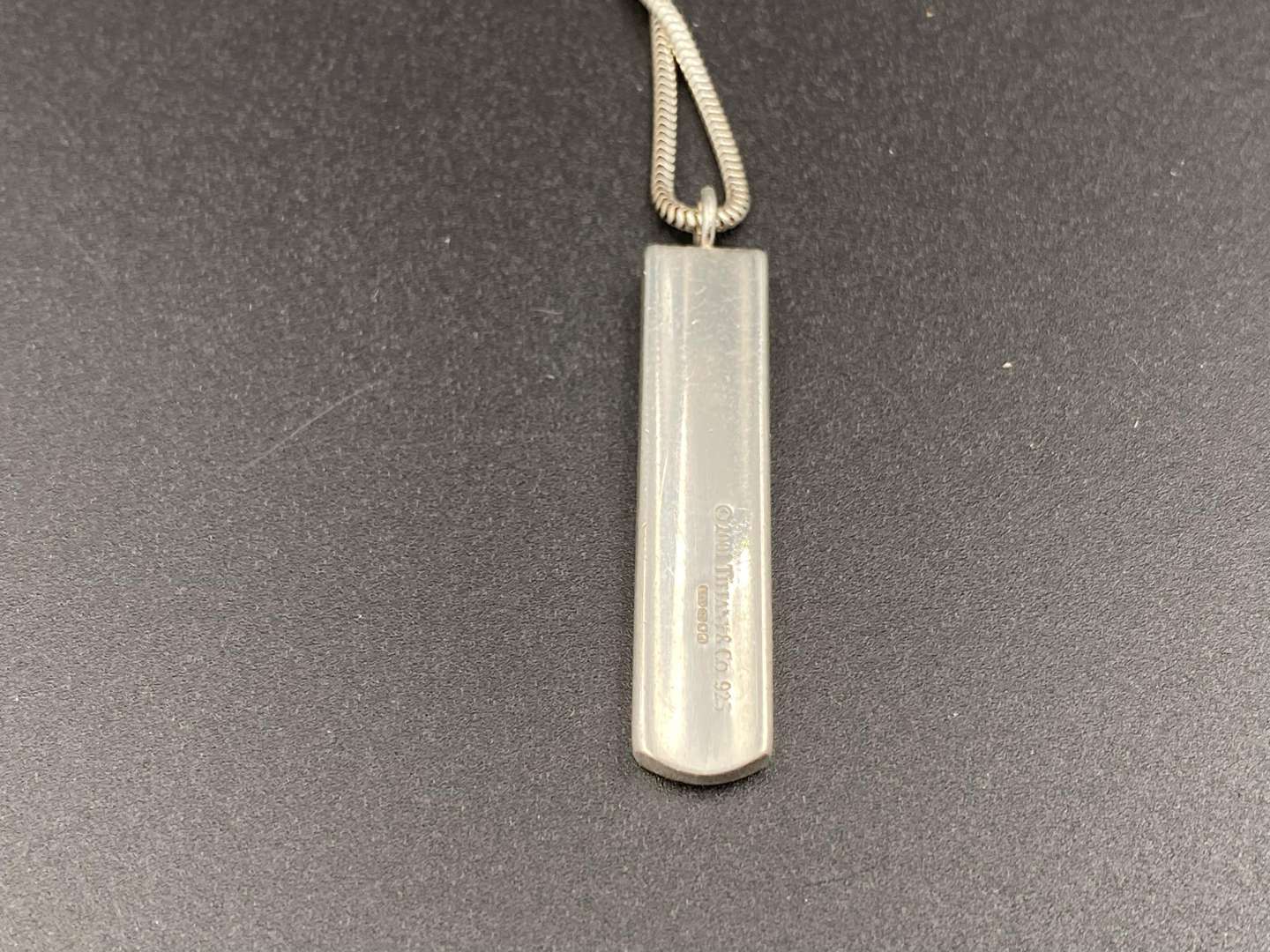 <p>TIFFANY & CO, .925 silver “1837”ingot pendent and snake link necklace.</p><p><br>&nbsp;</p>