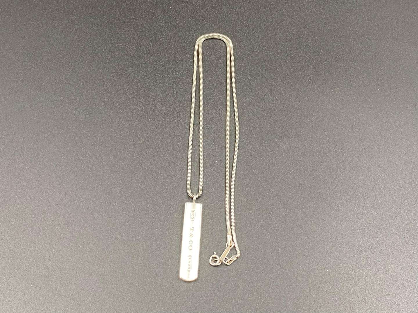 <p>TIFFANY & CO, .925 silver “1837”ingot pendent and snake link necklace.</p><p><br>&nbsp;</p>