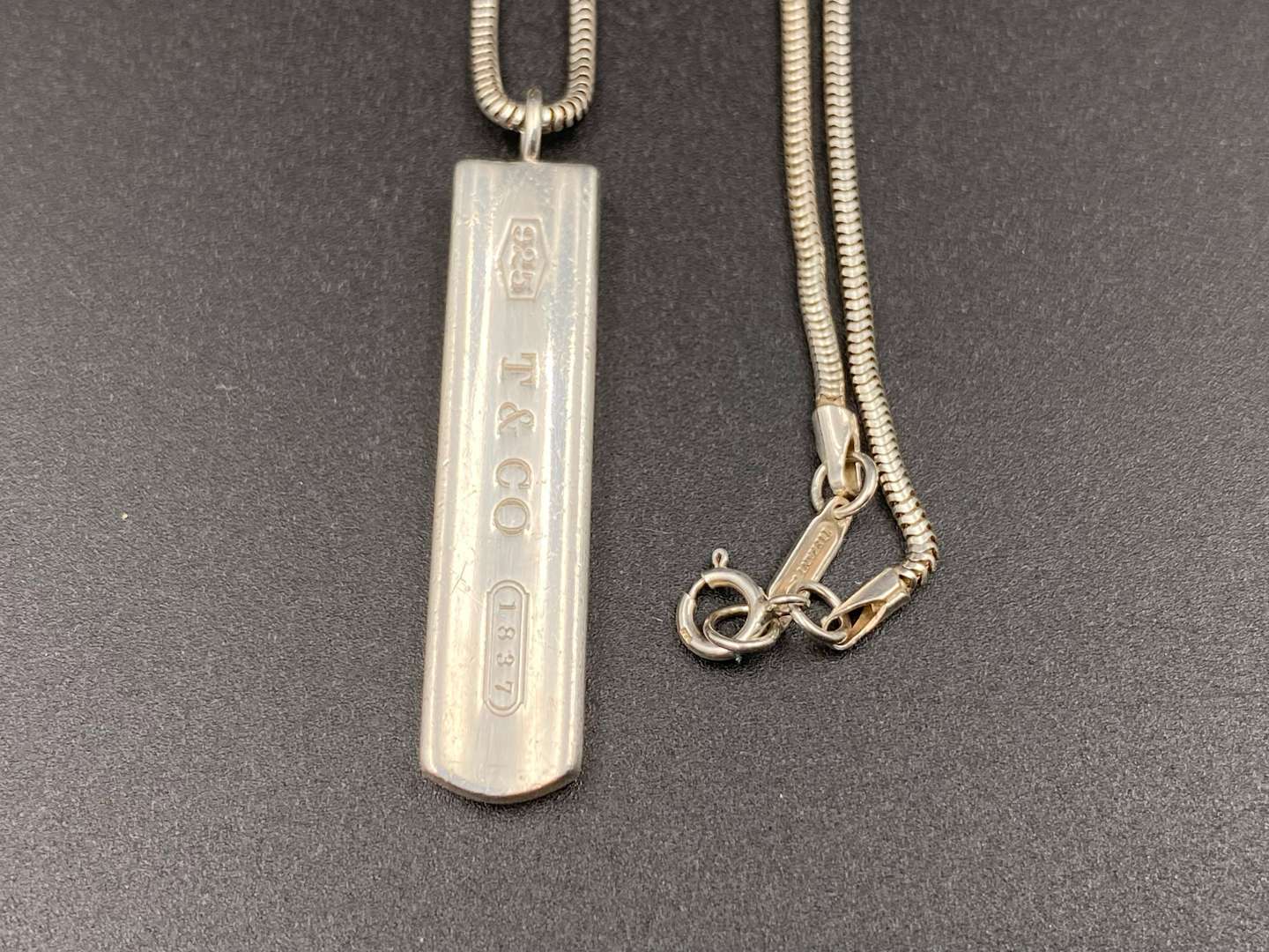 <p>TIFFANY & CO, .925 silver “1837”ingot pendent and snake link necklace.</p><p><br>&nbsp;</p>