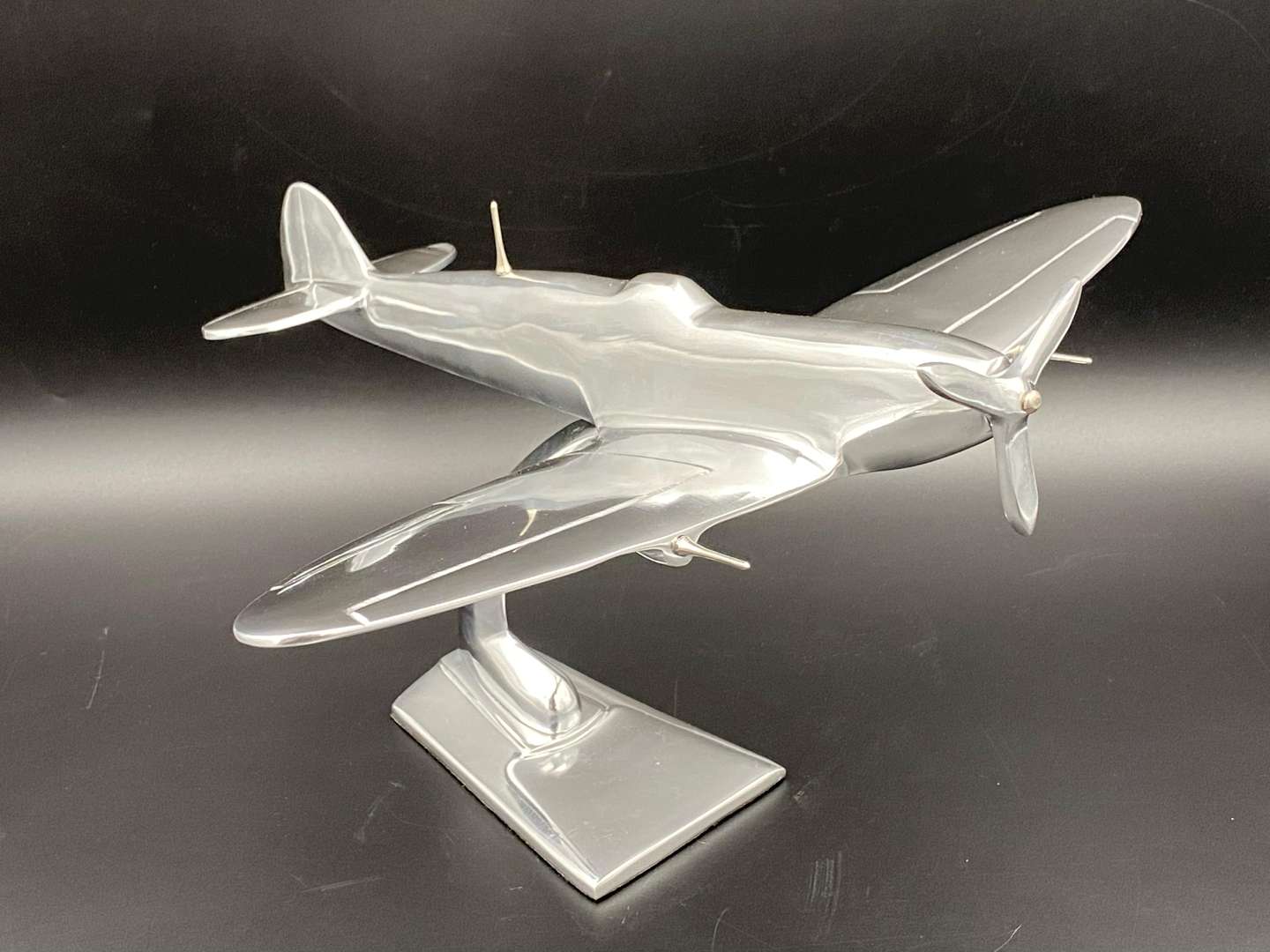 <p>A CAST ALUMINIUM MODEL OF A SPITFIRE FIGHTER PLANE,</p>