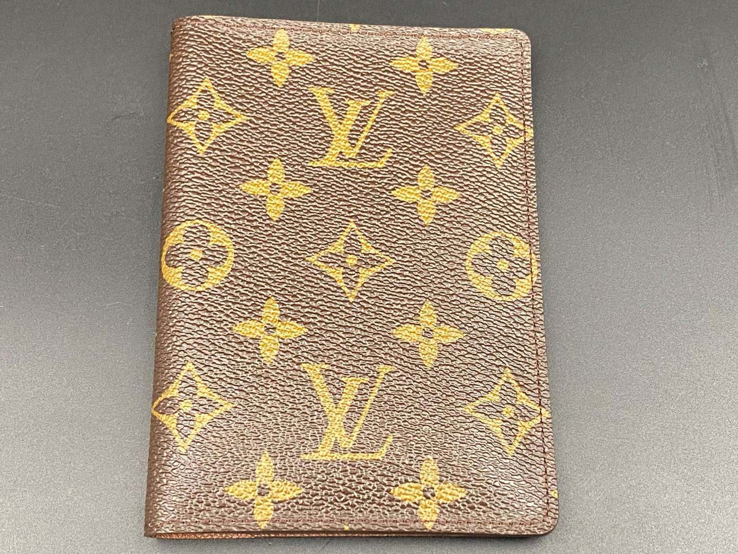 <p>LOUIS VUITTON, a monogrammed, coated canvas and leather passport cover</p>