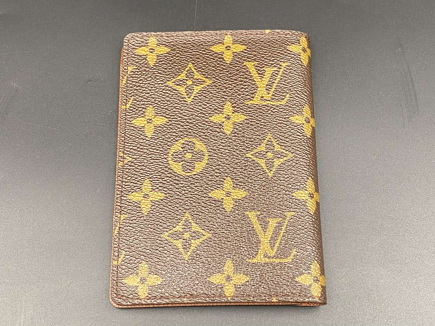 <p>LOUIS VUITTON, a monogrammed, coated canvas and leather passport cover</p>