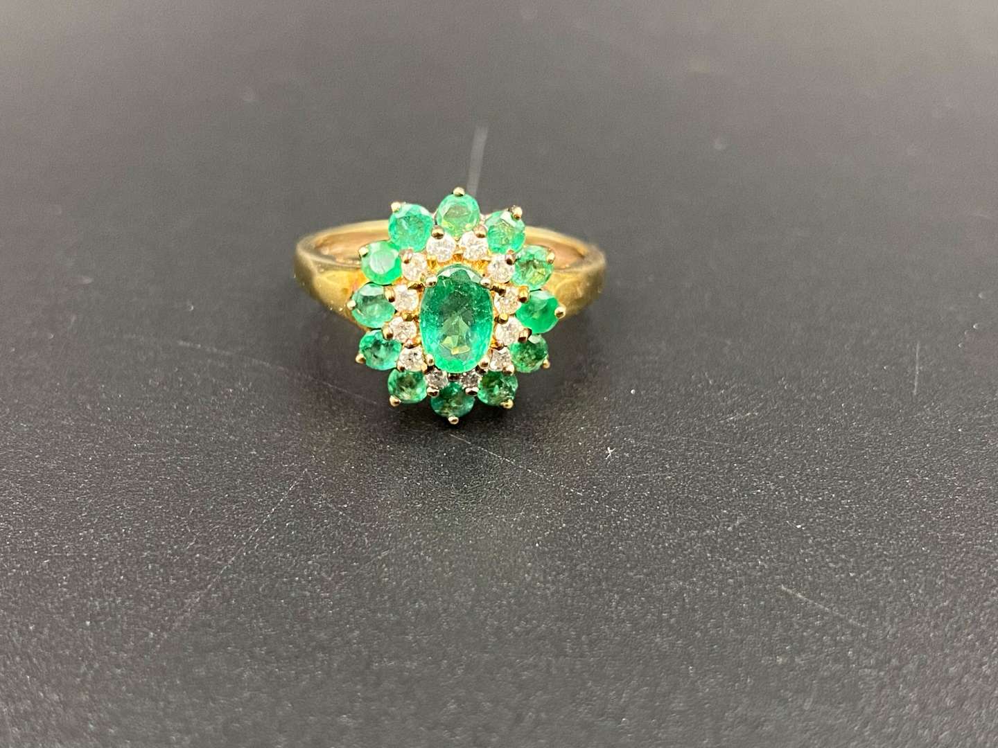 <p>An Emerald & Diamond 9ct gold cluster ring</p>