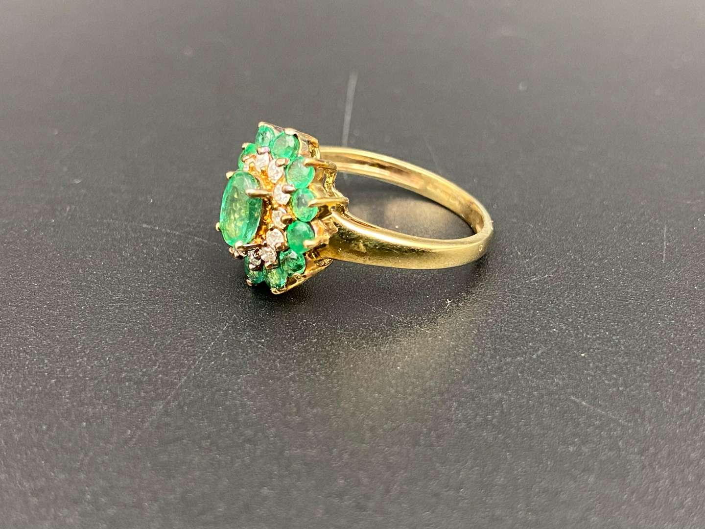 <p>An Emerald & Diamond 9ct gold cluster ring</p>