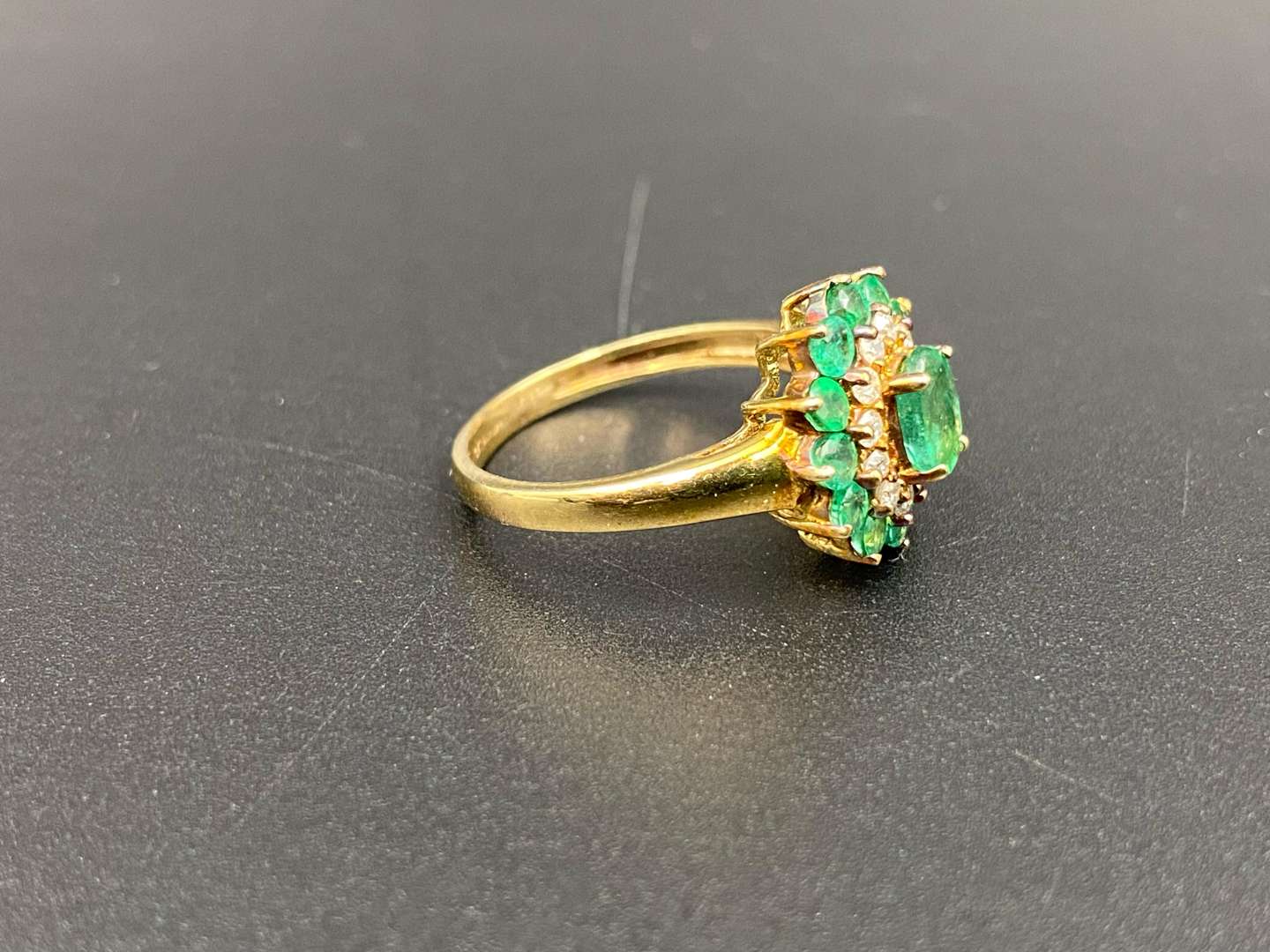 <p>An Emerald & Diamond 9ct gold cluster ring</p>