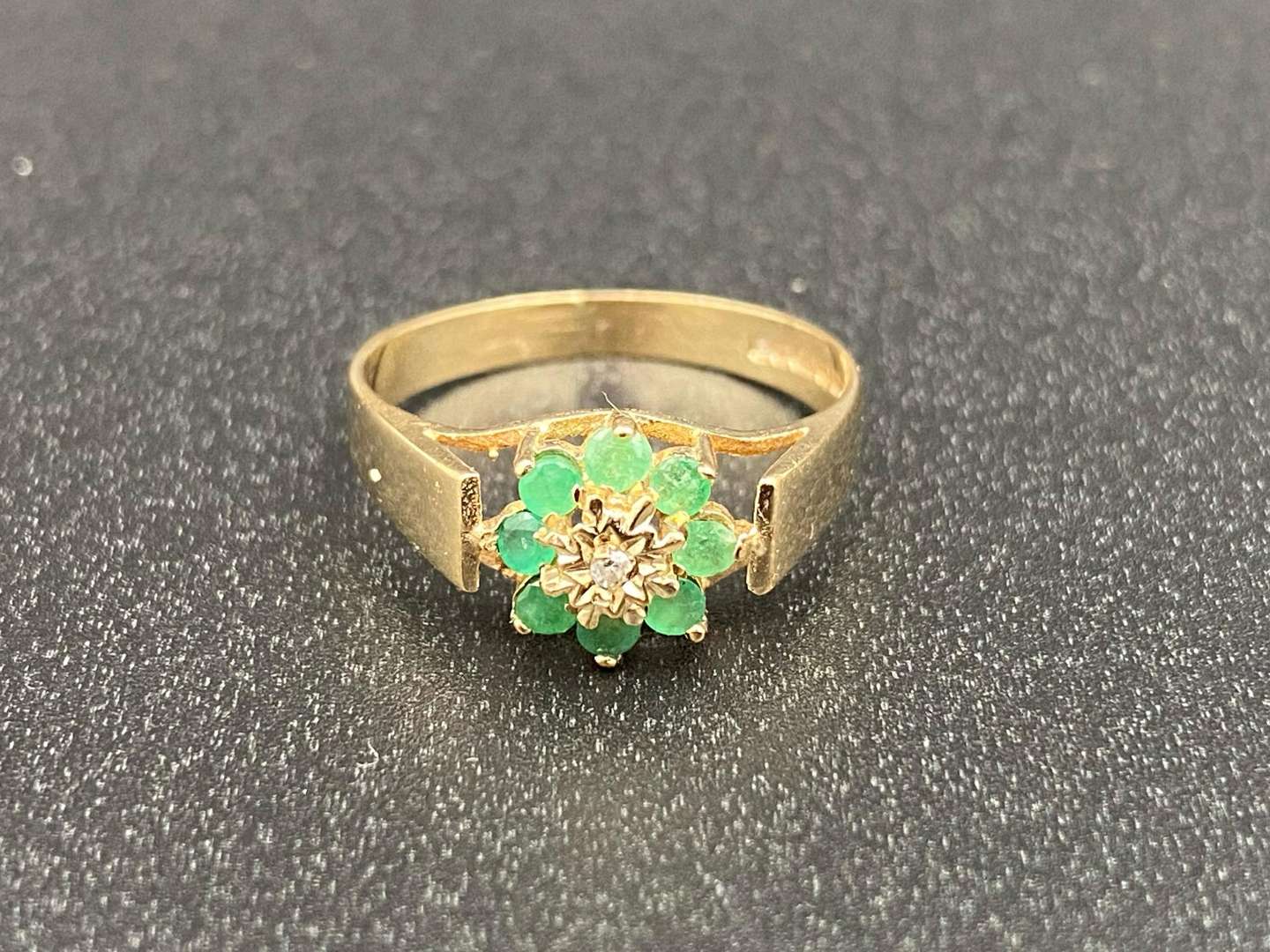 <p>An Emerald and Diamond flower head, 9ct gold ring,</p>