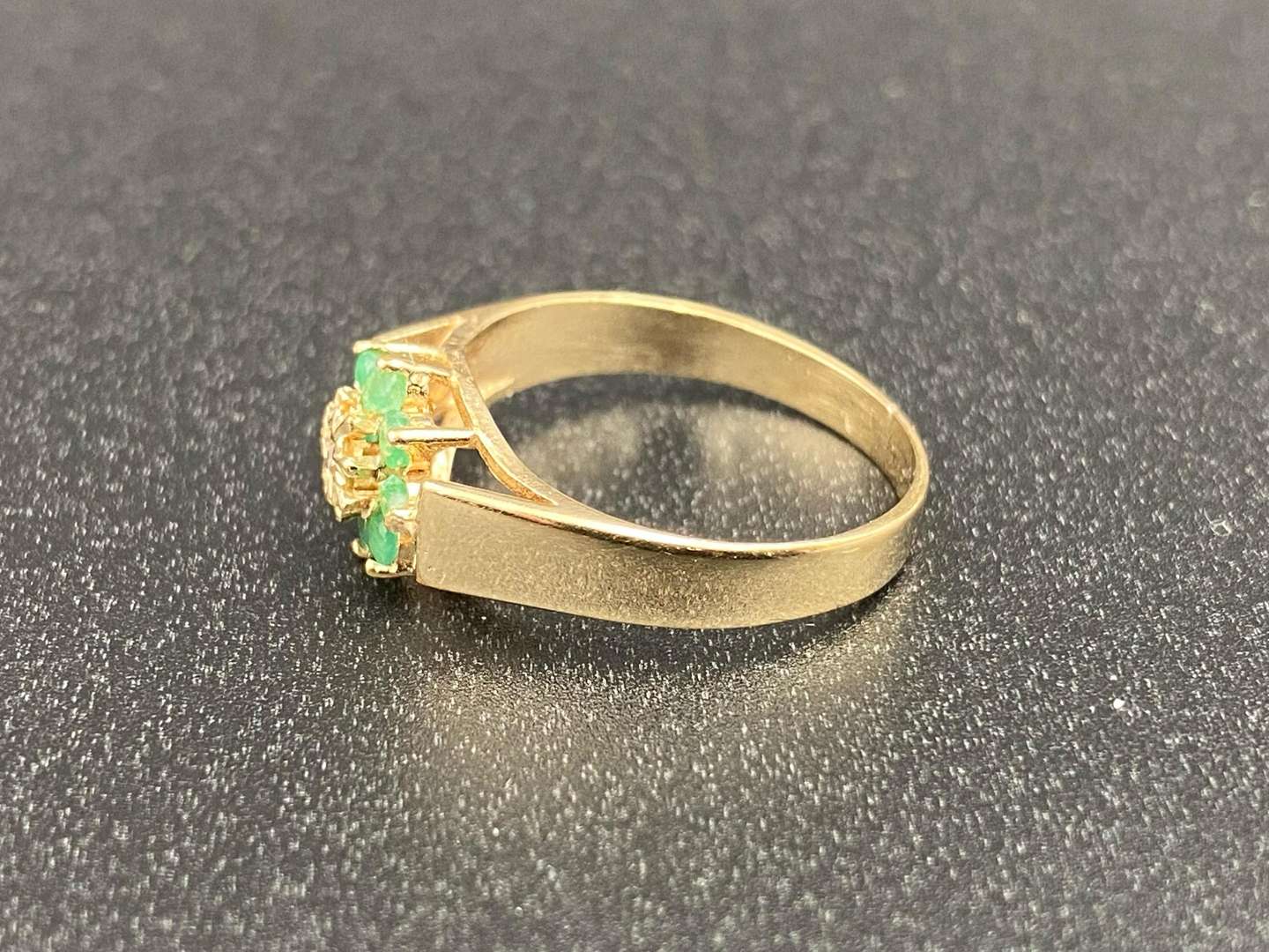 <p>An Emerald and Diamond flower head, 9ct gold ring,</p>