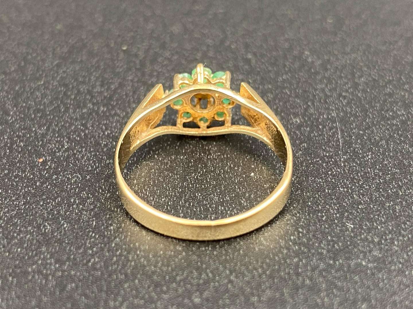 <p>An Emerald and Diamond flower head, 9ct gold ring,</p>