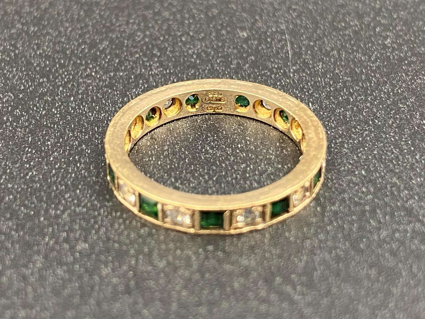 <p>A green and white paste set, 9ct gold, Eternity ring,</p>
