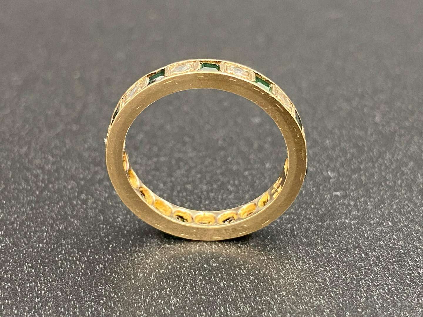 <p>A green and white paste set, 9ct gold, Eternity ring,</p>