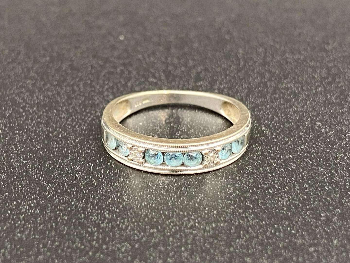 <p>A Topaz and Diamond set ½ Eternity ring</p>