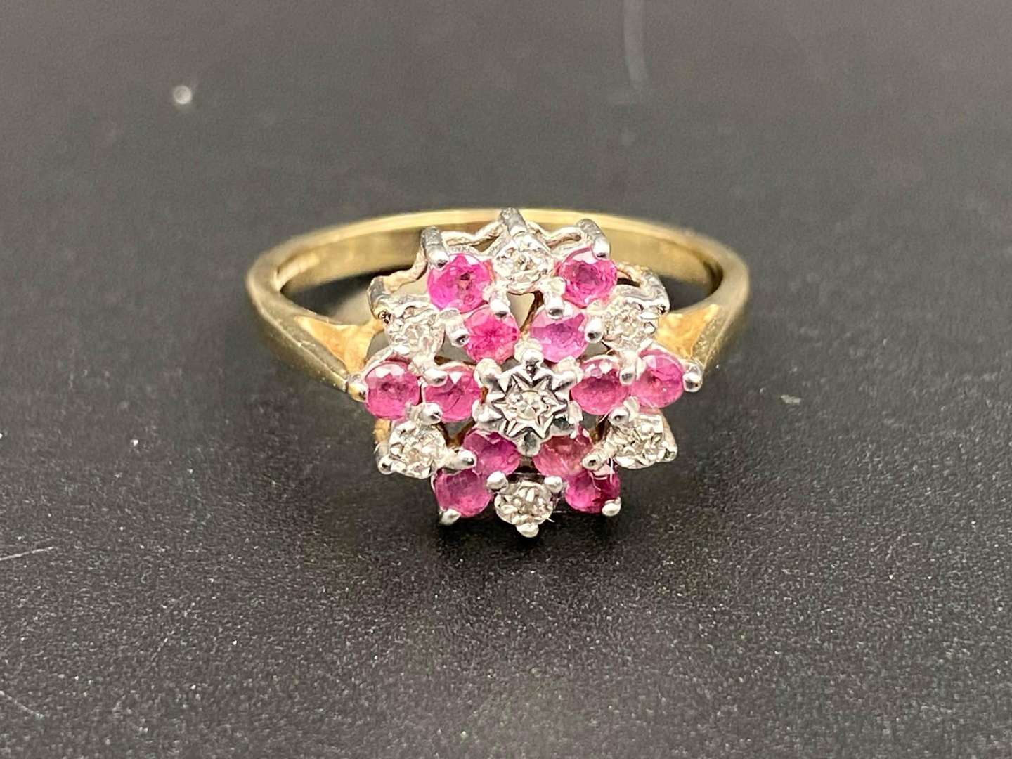 <p>A Ruby and Diamond set flower head, 9ct gold ring</p>