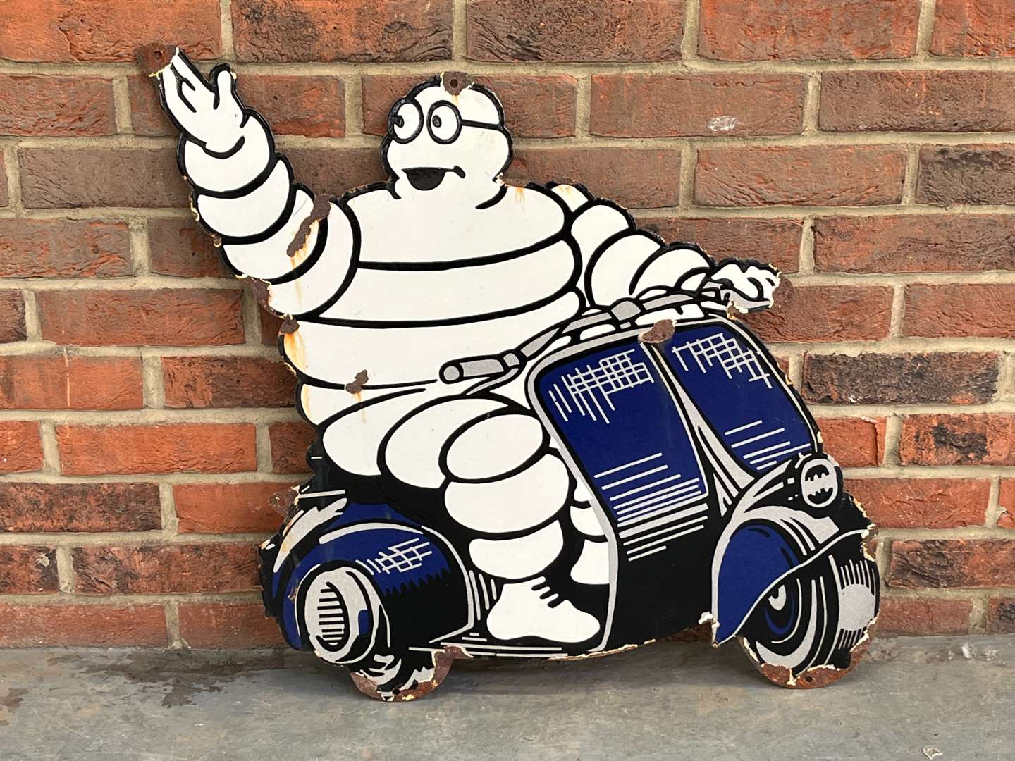 <p>Michelin Man On a Scooter Enamel Sign</p>