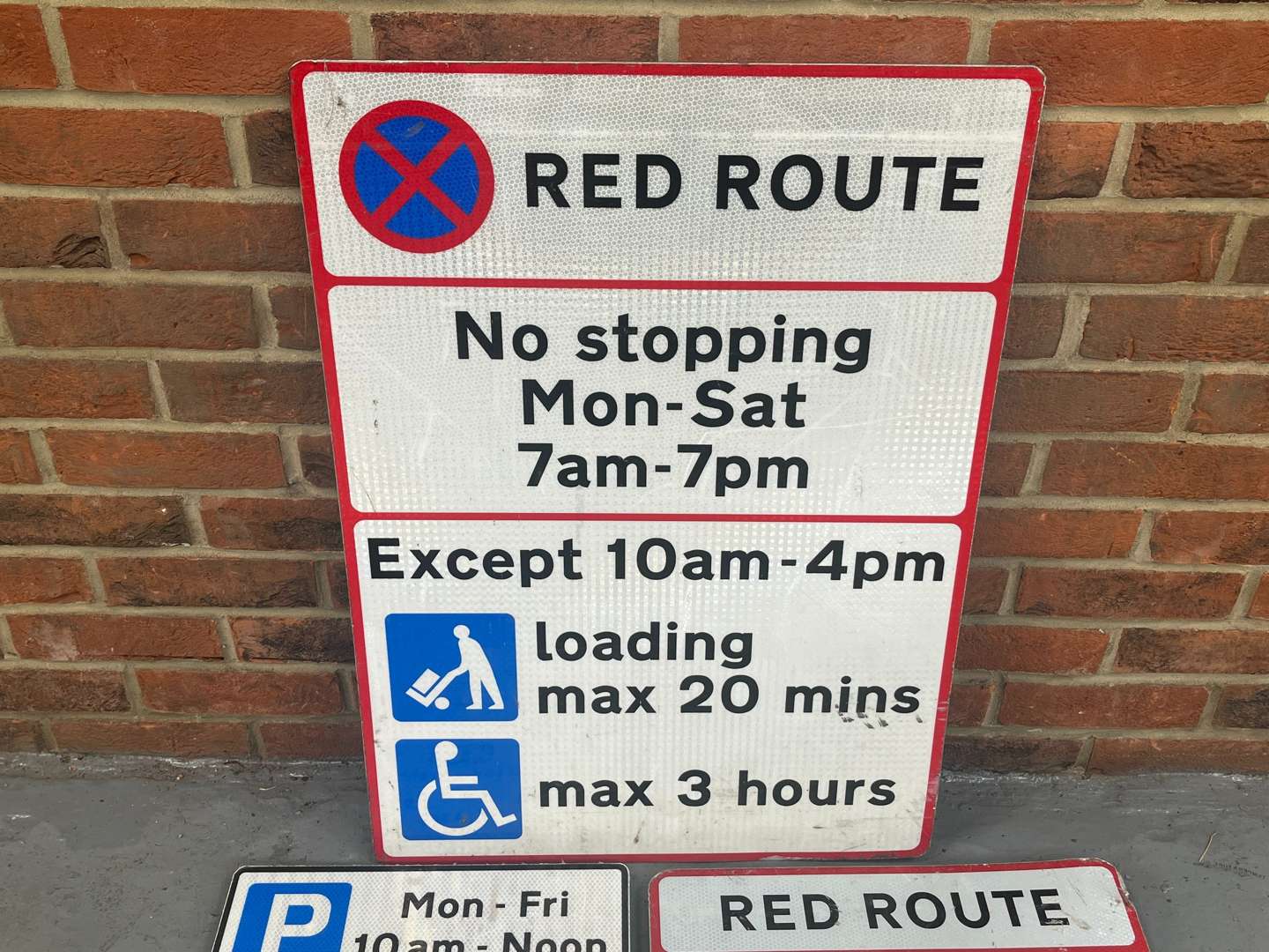 <p>Two Red Route Road Signs and One Other</p>