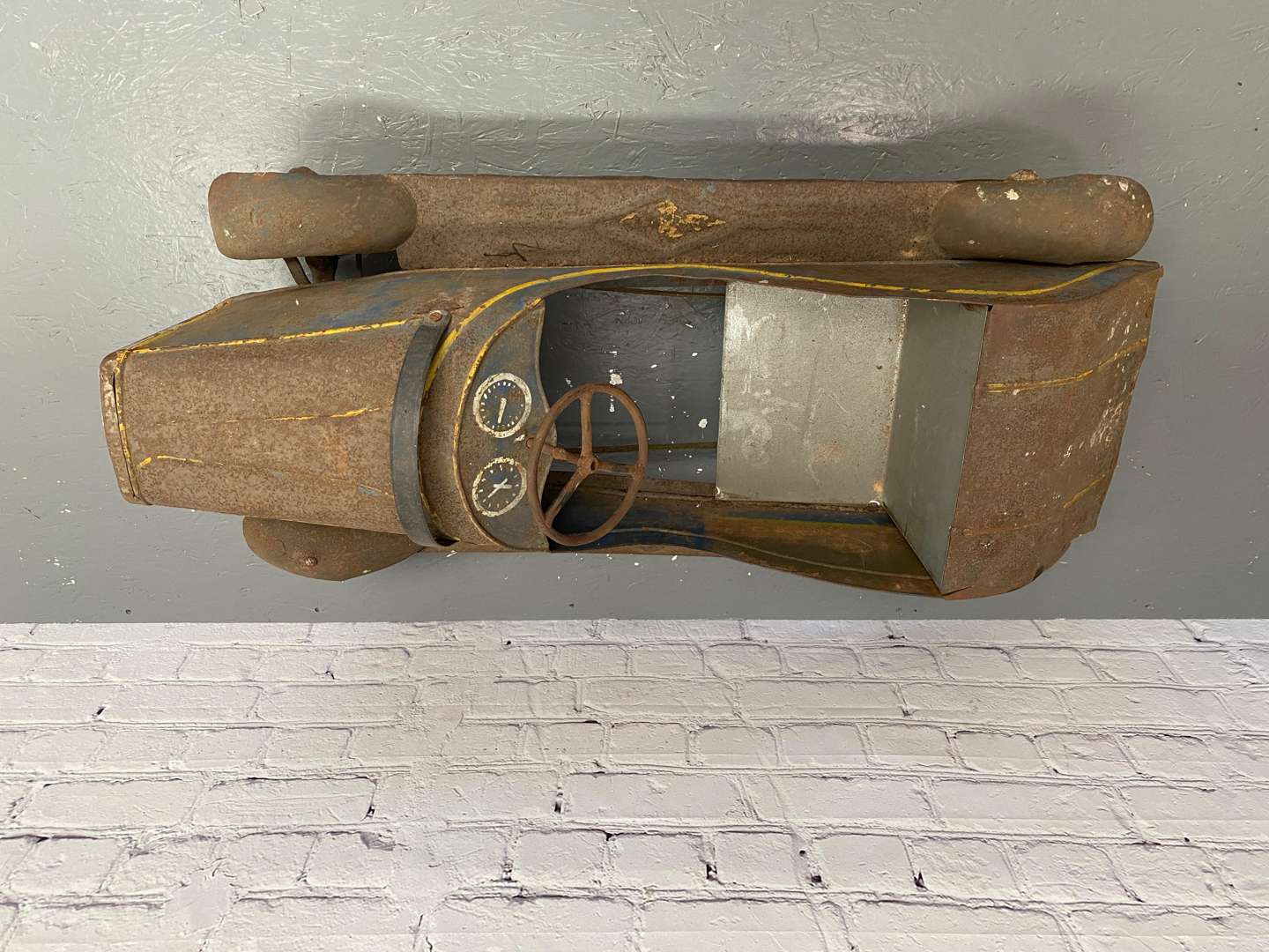 <p>A 1930s/40s pressed steel pedal car,</p>