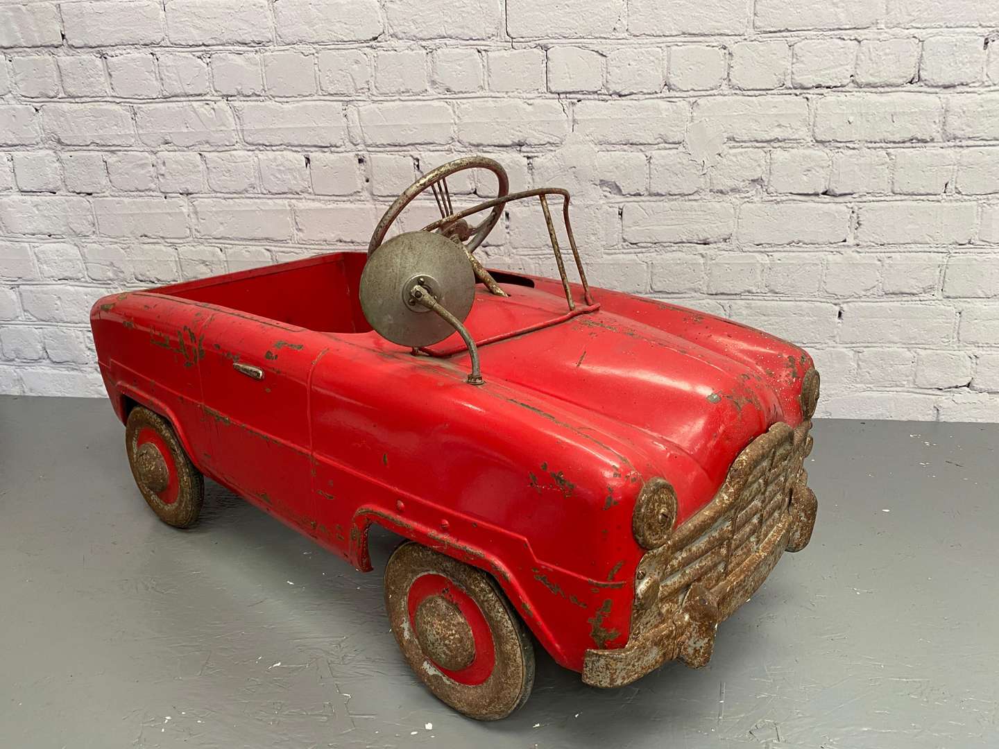 <p>Tri-ang, a mid 20th century pressed steel pedal car,</p>