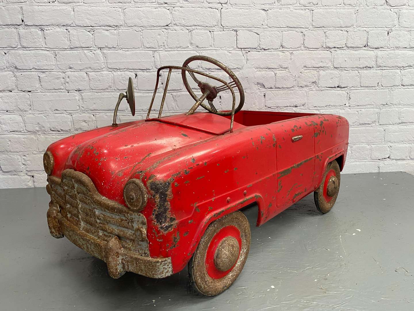 <p>Tri-ang, a mid 20th century pressed steel pedal car,</p>