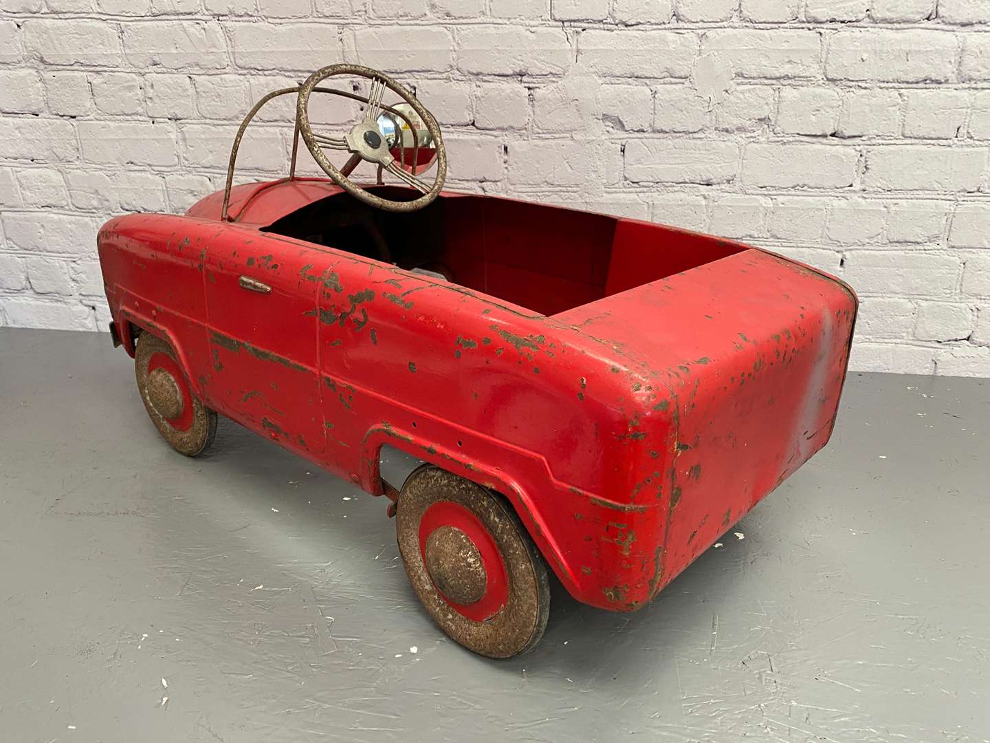 <p>Tri-ang, a mid 20th century pressed steel pedal car,</p>