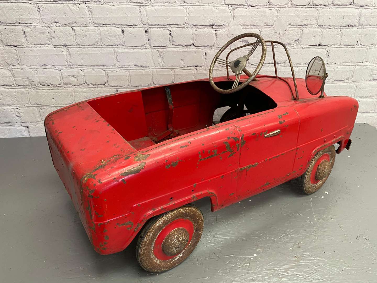 <p>Tri-ang, a mid 20th century pressed steel pedal car,</p>