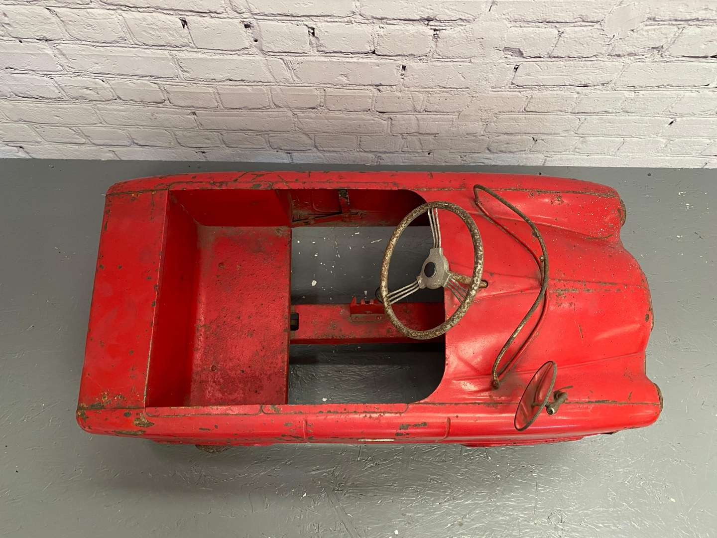 <p>Tri-ang, a mid 20th century pressed steel pedal car,</p>