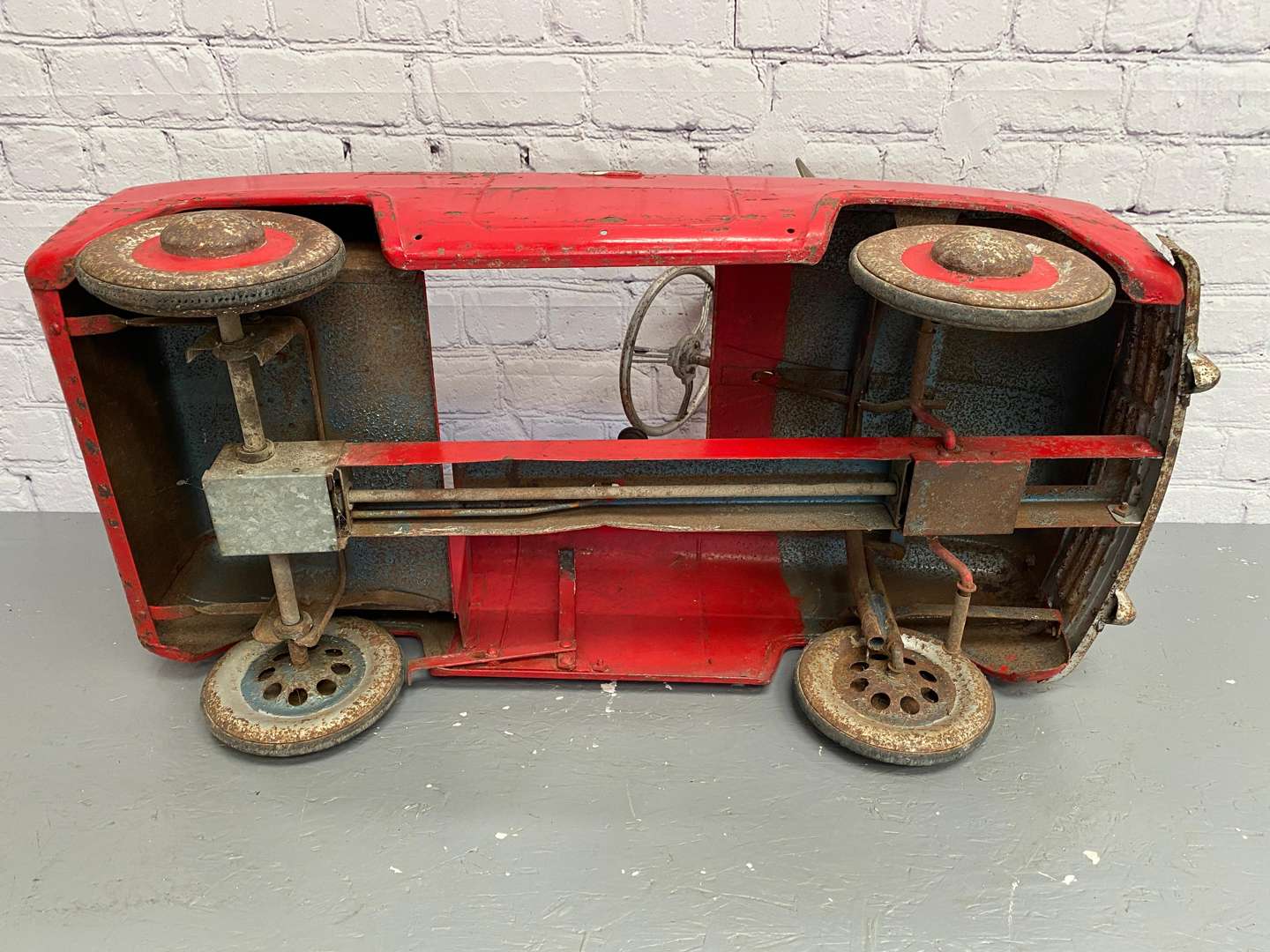 <p>Tri-ang, a mid 20th century pressed steel pedal car,</p>