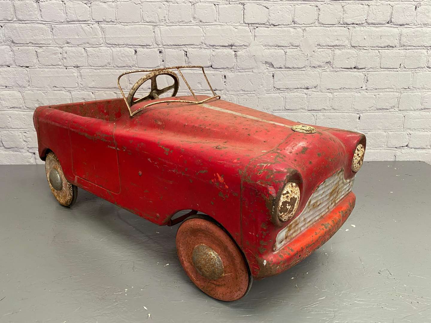 <p>Tri-ang, a mid 20th century pressed steel pedal car,</p>