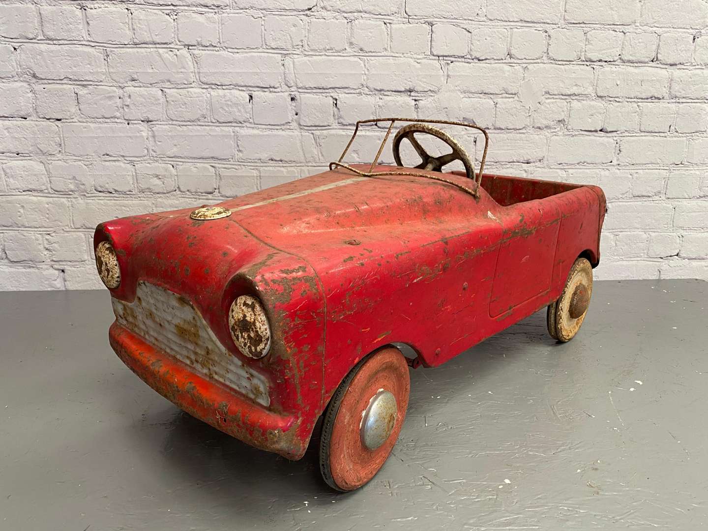 <p>Tri-ang, a mid 20th century pressed steel pedal car,</p>