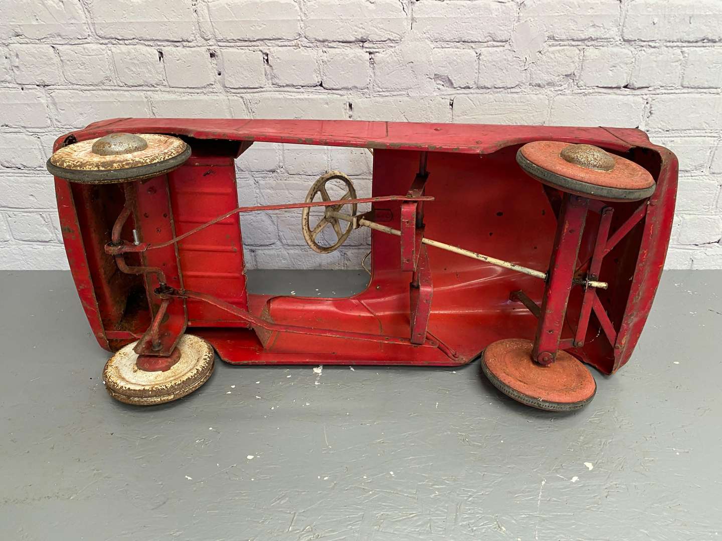 <p>Tri-ang, a mid 20th century pressed steel pedal car,</p>