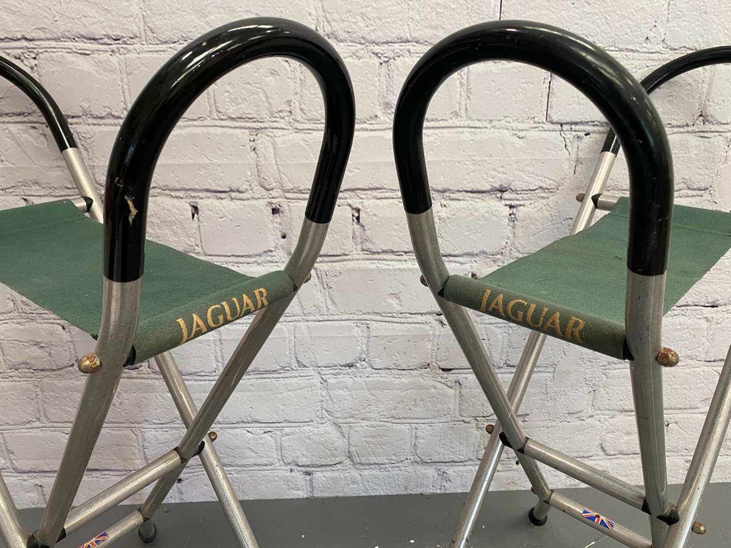 <p>Jaguar, a pair of late 20th century aluminium and canvas folding stools,&nbsp;</p>