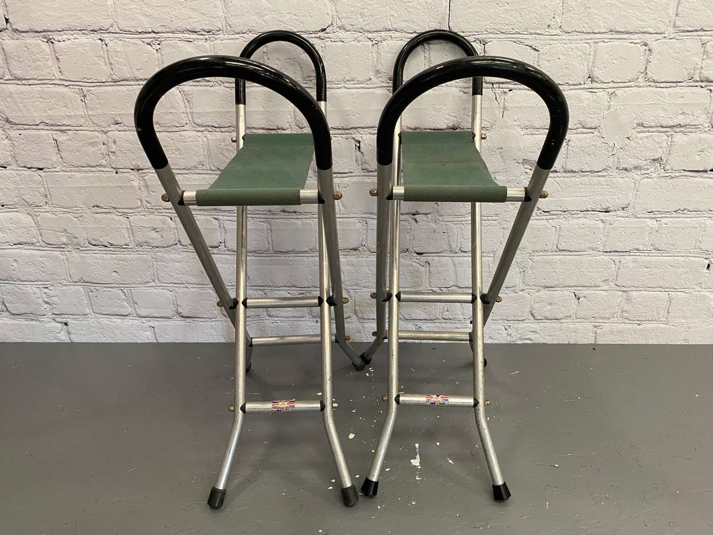 <p>Jaguar, a pair of late 20th century aluminium and canvas folding stools,&nbsp;</p>