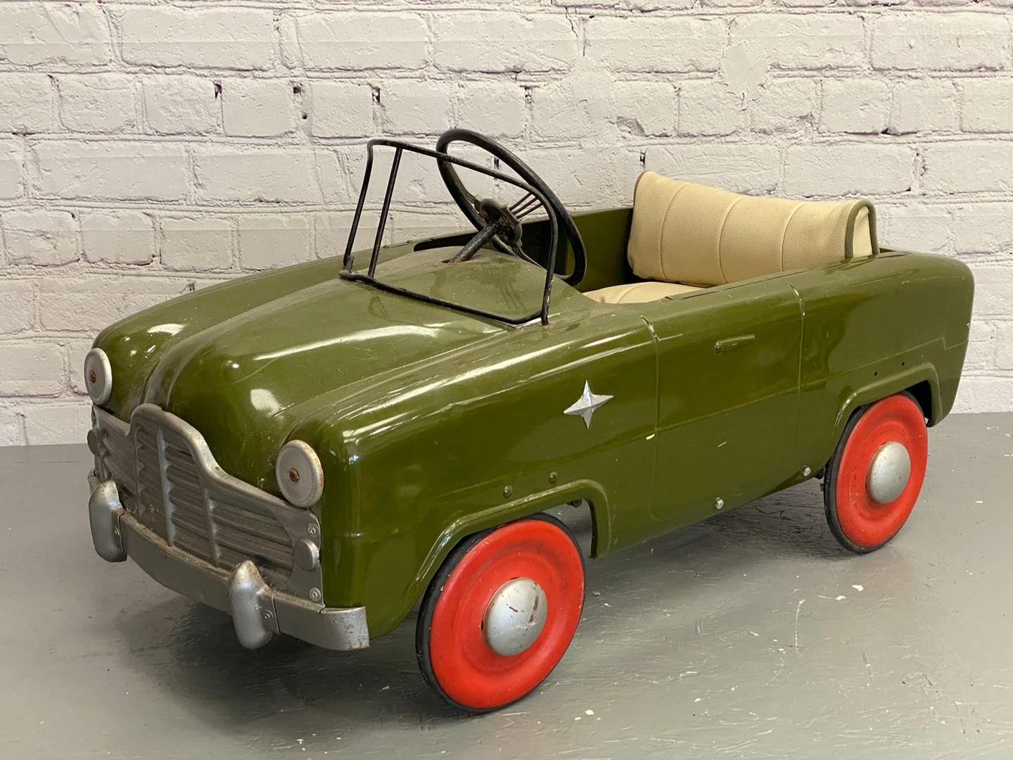 <p>Tri-ang, a mid 20th century pressed steel pedal car,&nbsp;</p>