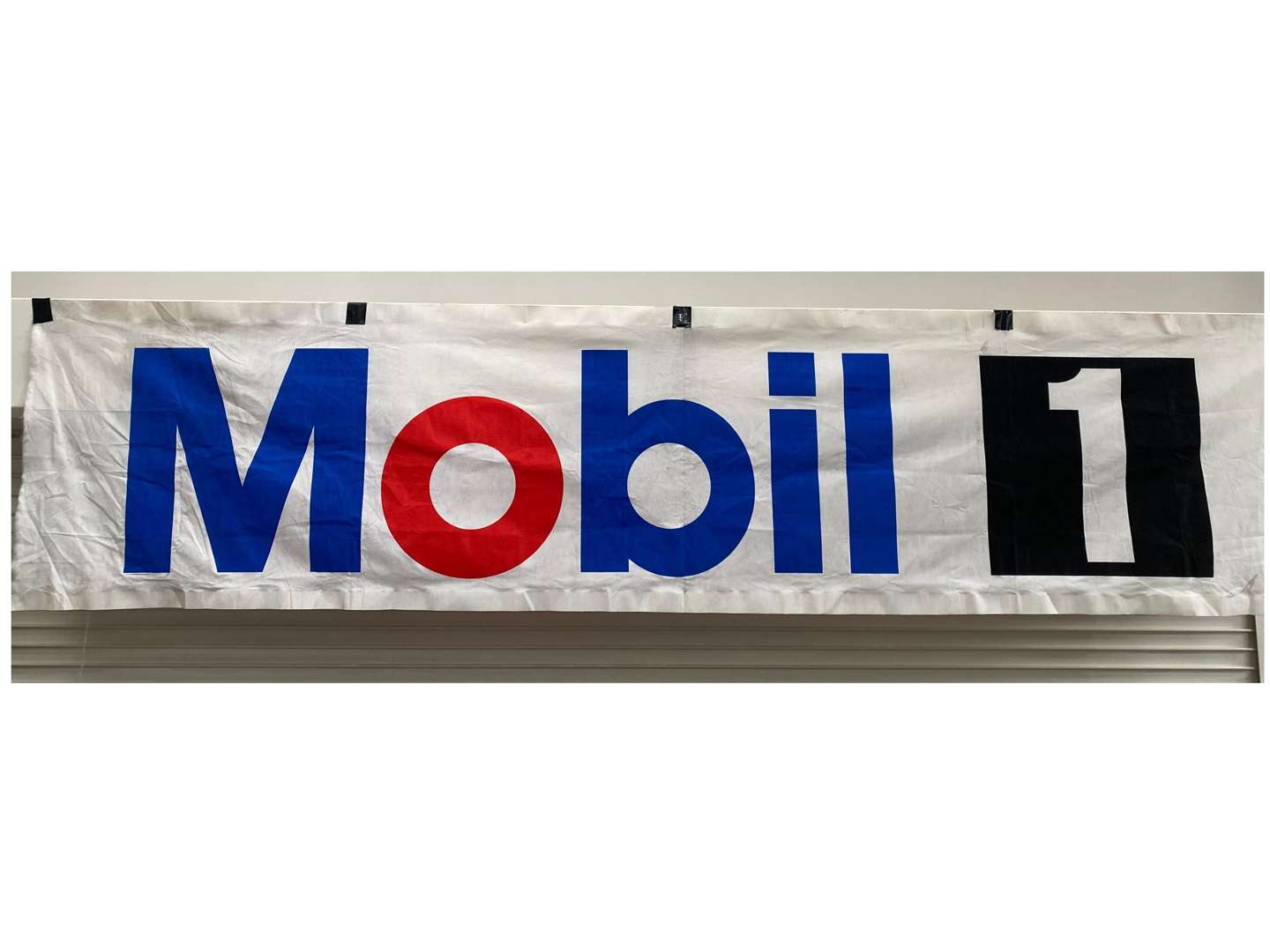 <p>Mobil 1, a late 20th century cloth banner,</p>