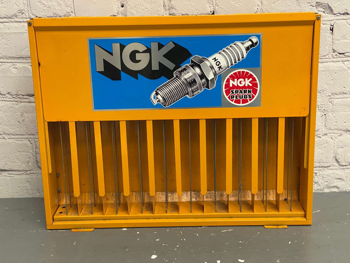 <p>NGK, a modern painted steel, wall mounted spark-plug dispenser,</p>