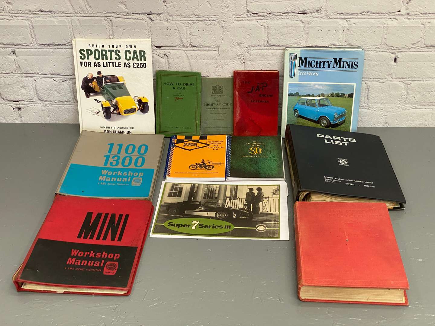 <p>A mixed lot comprising assorted automotive books and manuals,</p>
