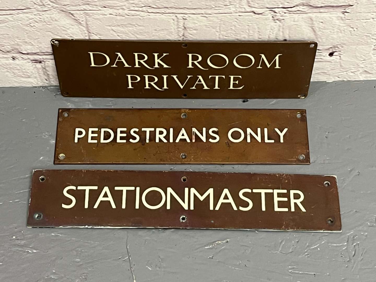<p>Three Bronze Signs&nbsp;</p>
