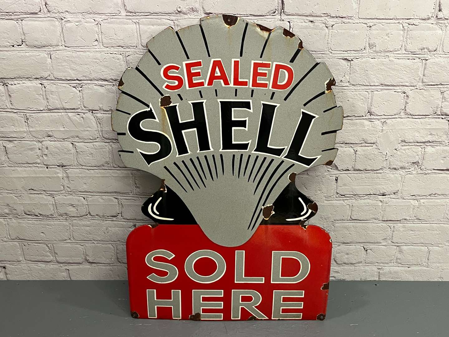 <p>Sealed Shell Sold Here Enamel Sign</p>